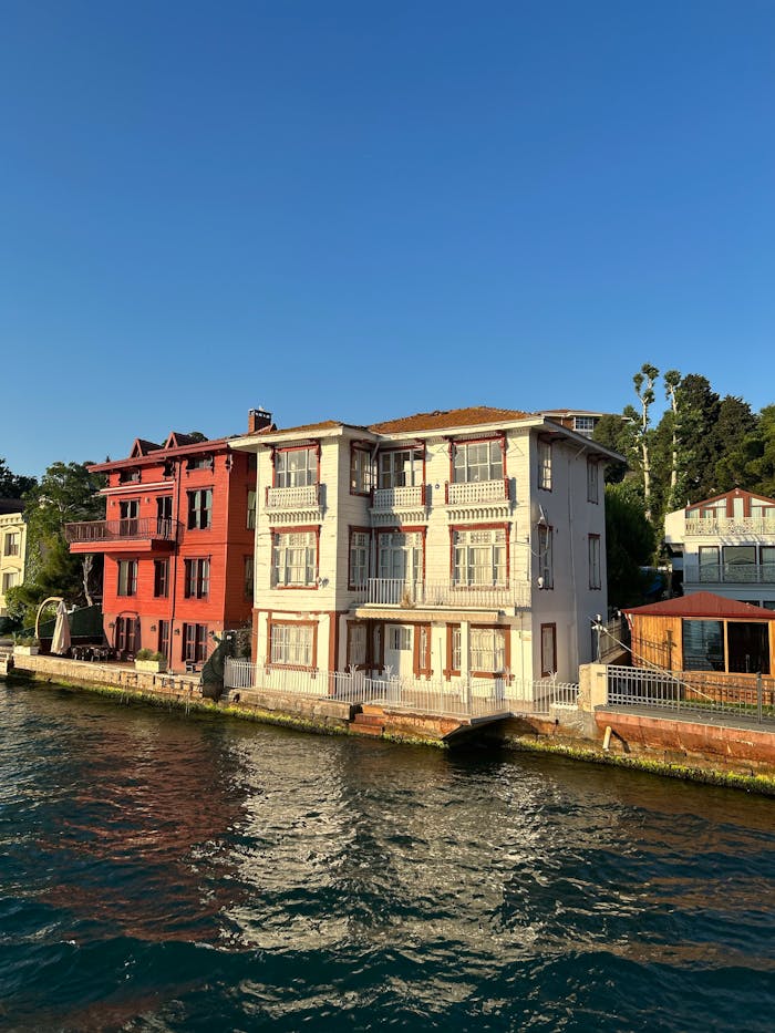 Elegant waterfront villas with traditional architecture along the Bosphorus at sunset.